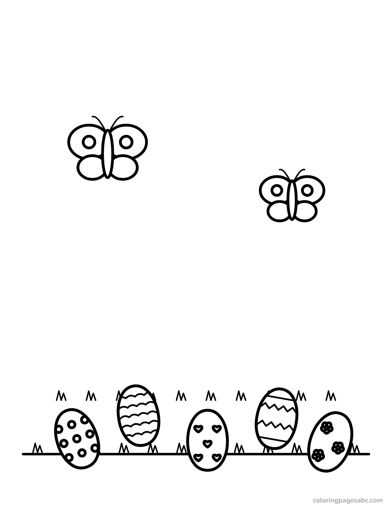 Five decorated Easter eggs hidden in the grass