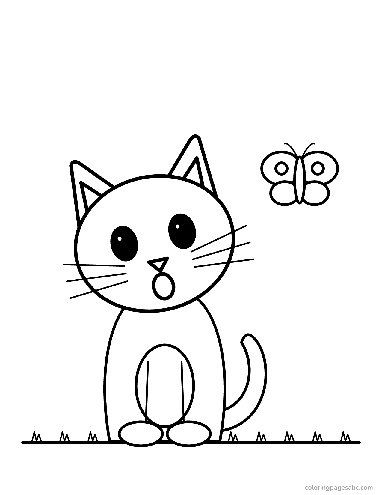 Surprised kitten looking at a butterfly in the grass
